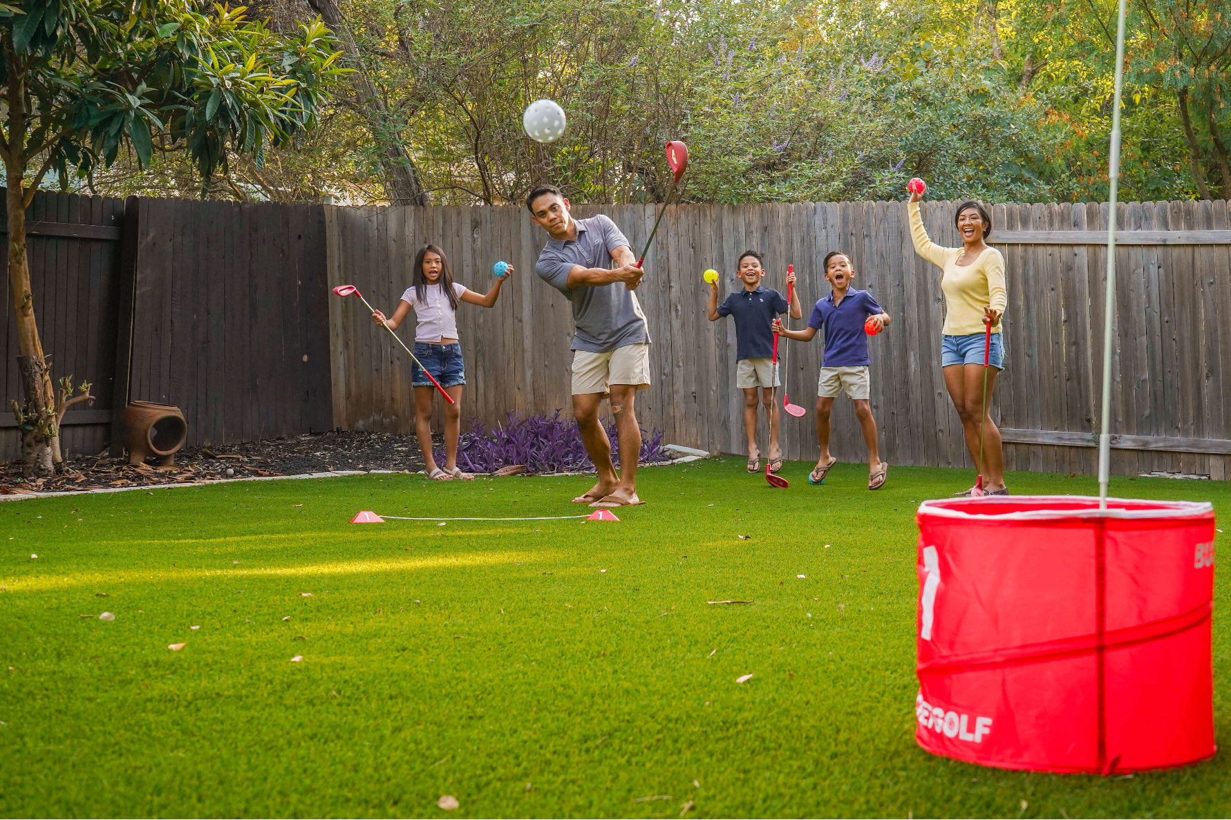 BucketGolf family playing in a backyard