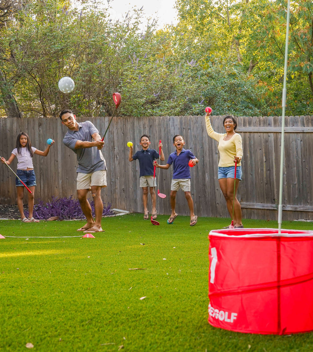Friends playing BucketGolf at a summer cookout
